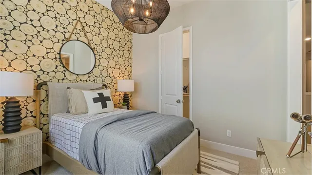 a bedroom with a bed and a chandelier