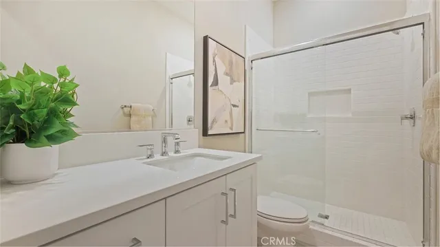 a bedroom with bed and a mirror