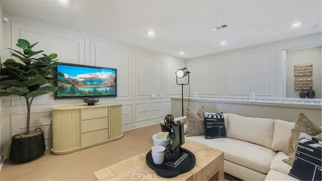 a living room with furniture and a painting on the wall