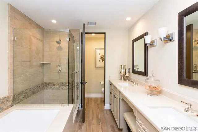 a bathroom with a granite countertop sink mirror and shower