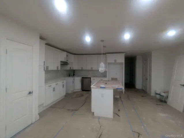 a utility room with cabinets dryer and washer