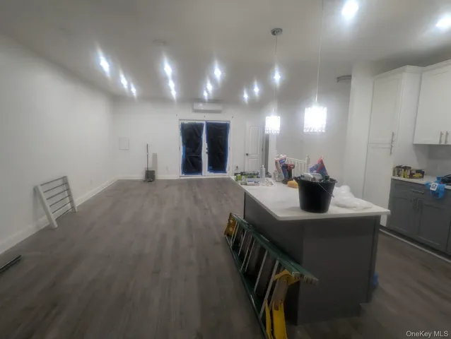a kitchen with kitchen island a sink appliances and a counter top space