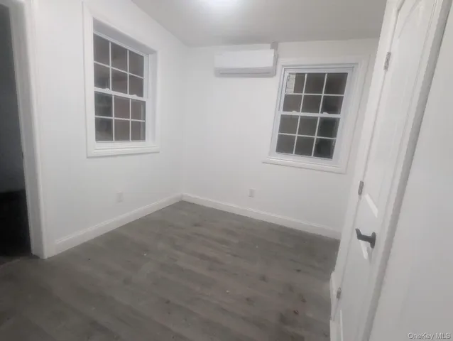 an empty room with windows and entrance