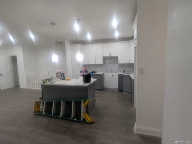 a kitchen with kitchen island a sink table and chairs