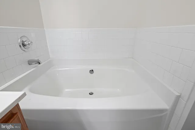 a white bath tub sitting in a bathroom