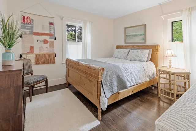 a bed sitting in a bedroom and painting on the wall