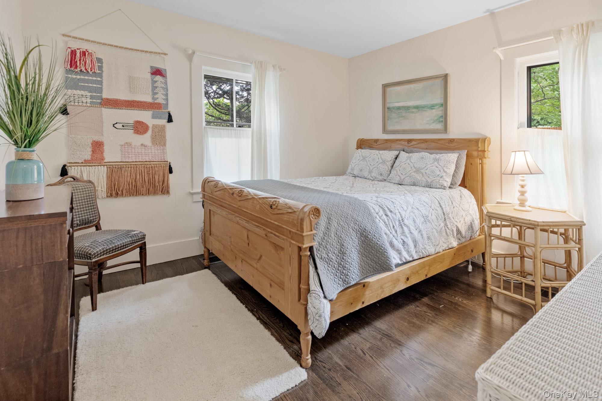 10 Pleasant Lane East Hampton, NY 11937 - Photo 13 of 15 a bed sitting in a bedroom and painting on the wall