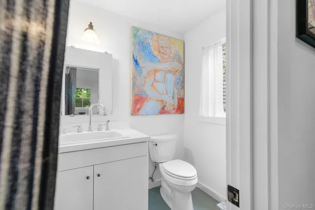 a bathroom with a toilet a sink and mirror