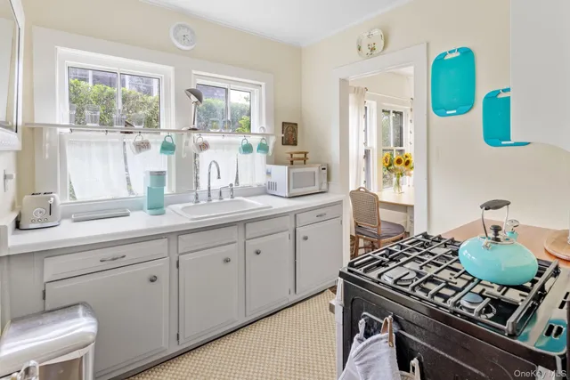 a kitchen with kitchen island granite countertop a sink stove and cabinets