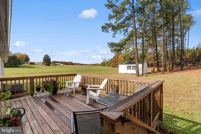 a view of a balcony with wooden floor and outdoor seating