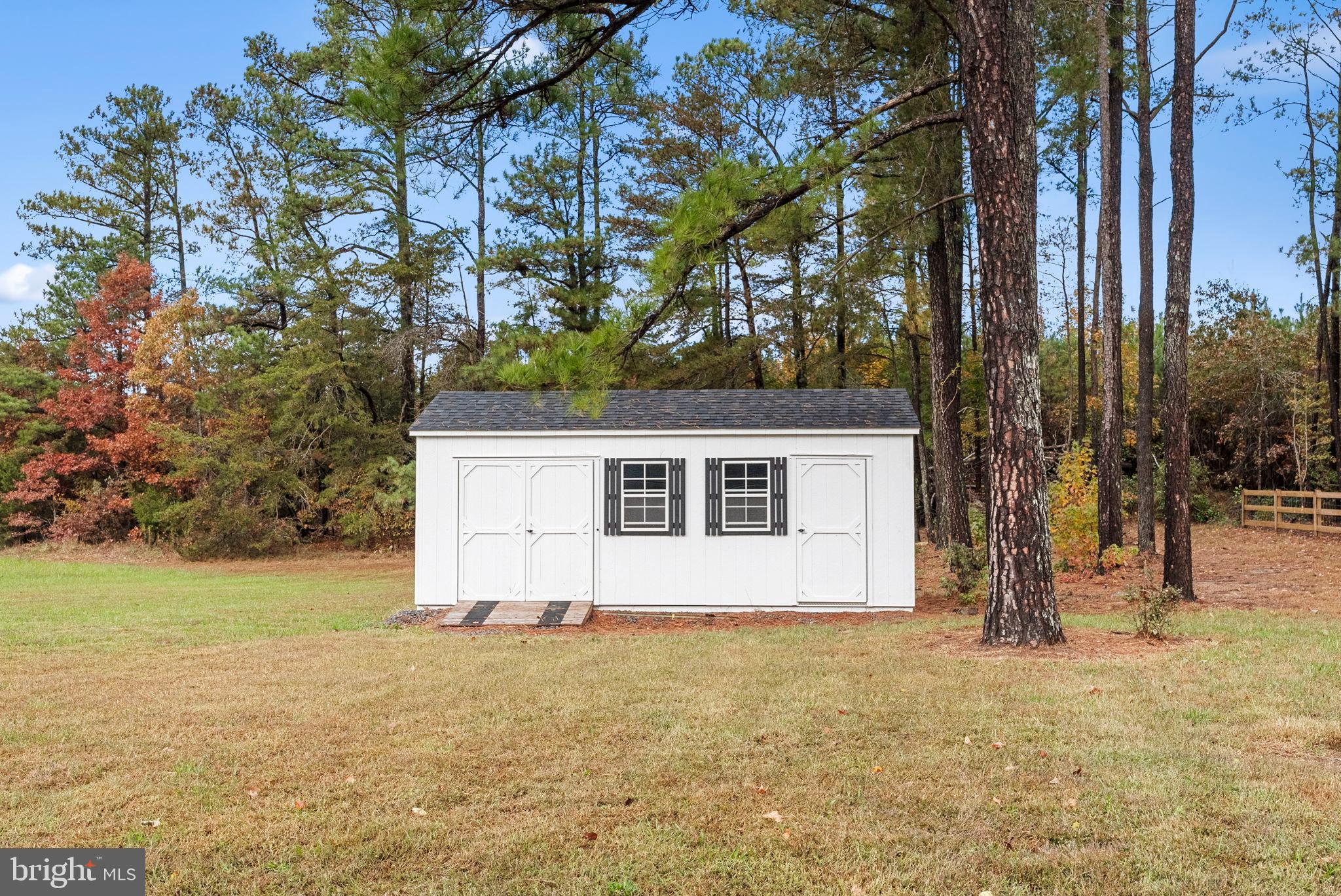 21287 Sparta Road Milford, VA 22514 - Photo 35 of 35 Charming shed nestled among tall pines.