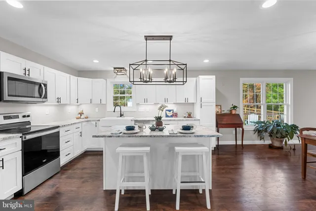 a kitchen with stainless steel appliances granite countertop a stove and cabinets