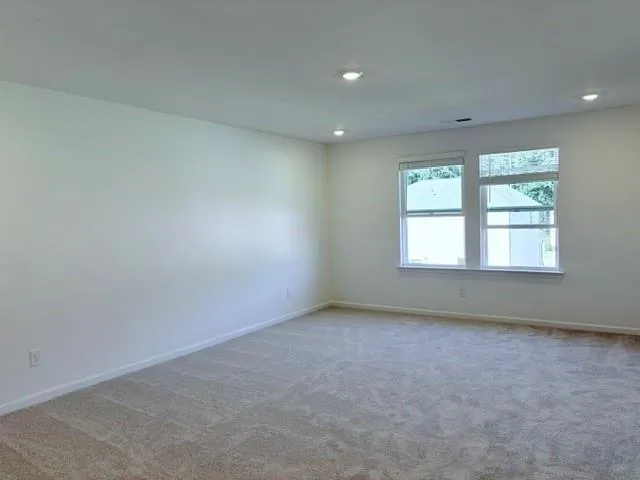 a bathroom with a glass door shower and toilet