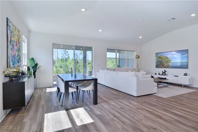 a view of a livingroom with furniture wooden floor and windows