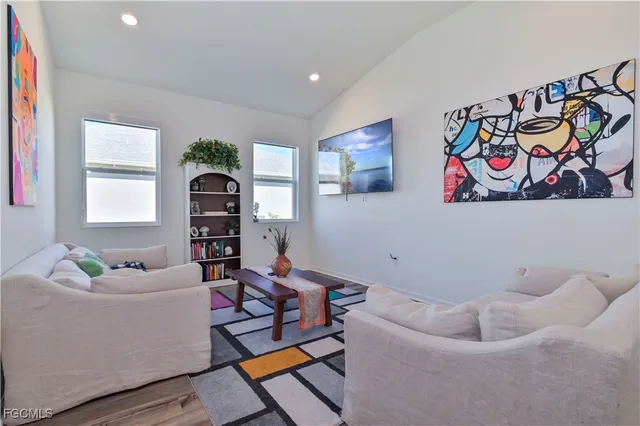 a living room with furniture and a painting