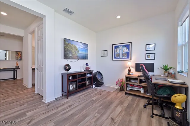 a workspace with wooden floor and a window