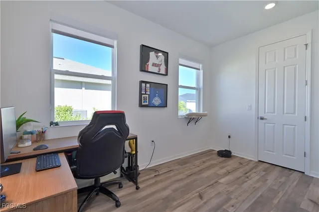 a room with lots of white furniture and chandelier