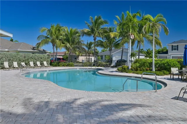a view of a house with swimming pool and sitting area