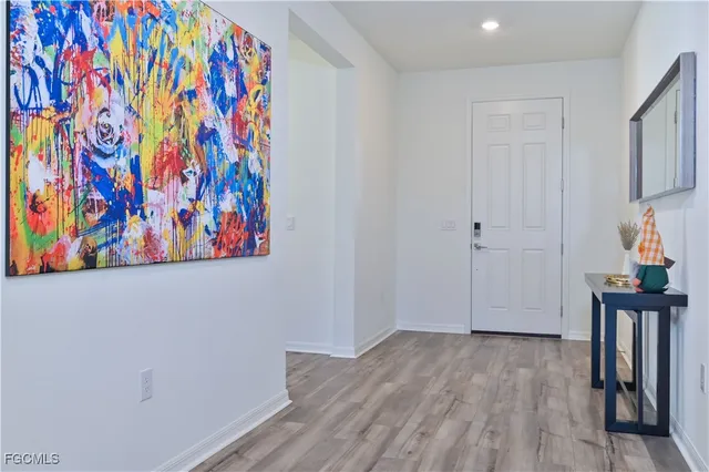 a kitchen with a table chairs refrigerator microwave and cabinets