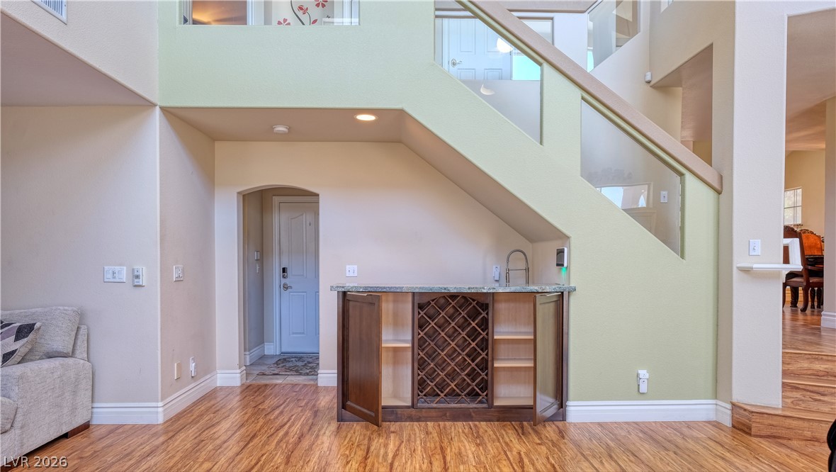 3704 North Campbell Road Las Vegas, NV 89129 - Photo 22 of 38 Custom cabinetry and a wet bar nestle perfectly beneath a striking modern staircase.