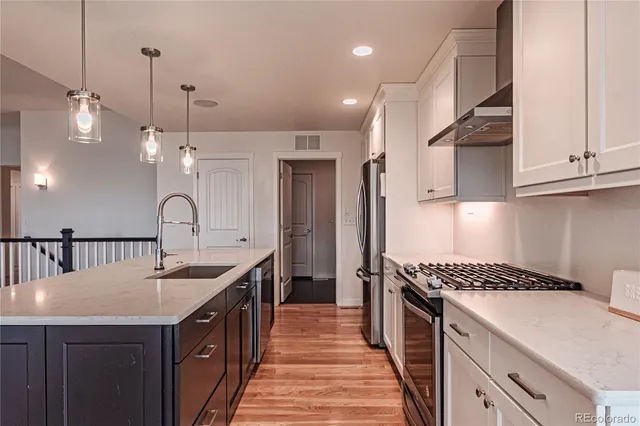 a kitchen with sink a stove and cabinets