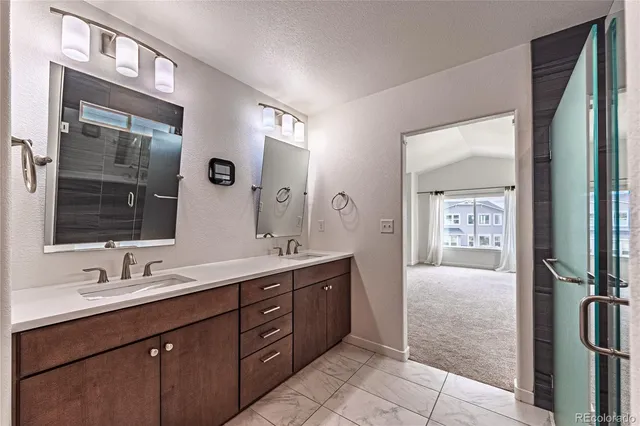 a spacious bathroom with a double vanity sink a and mirror