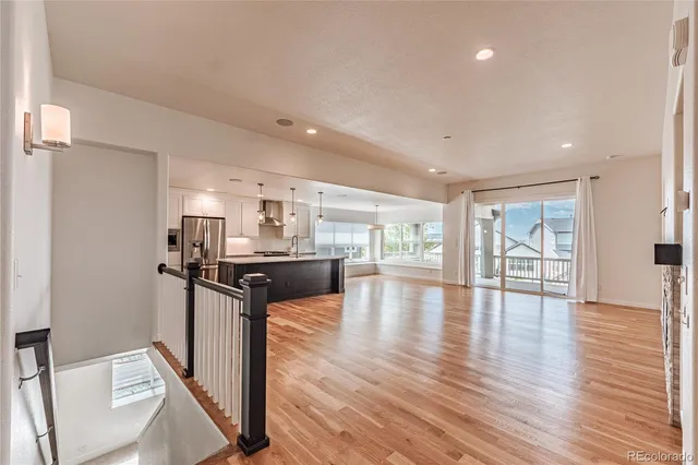 a kitchen with stainless steel appliances granite countertop a refrigerator and a stove top oven