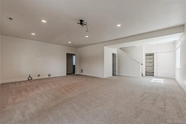 a view of an empty room with a ceiling fan