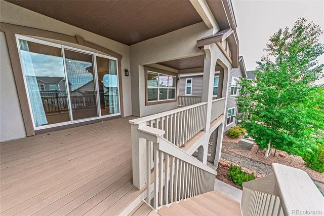 a view of a house with balcony and wooden floor