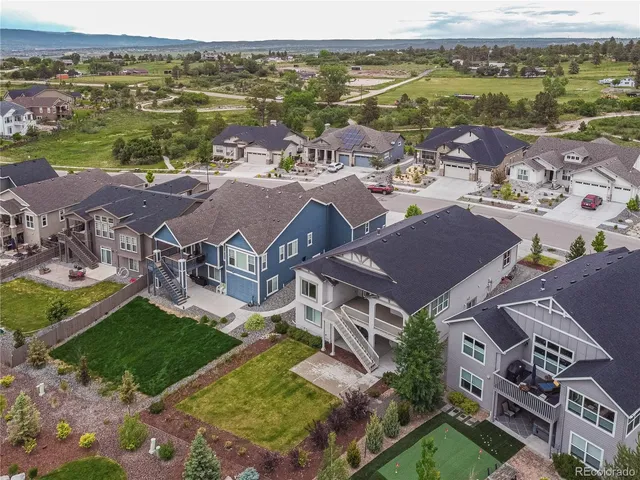 an aerial view of residential houses with outdoor space