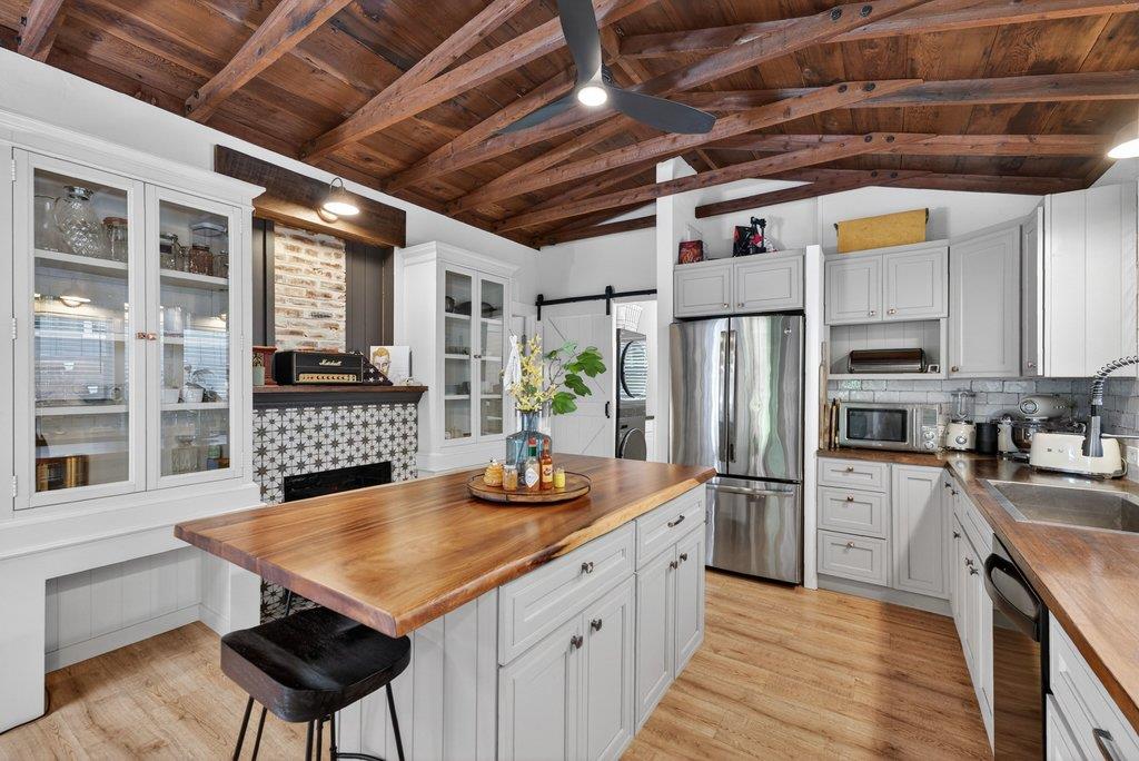 125 Shadowbrook Road Ben Lomond, CA 95005 - Photo 23 of 60 a kitchen with stainless steel appliances granite countertop a sink a stove a refrigerator cabinets and a counter top space