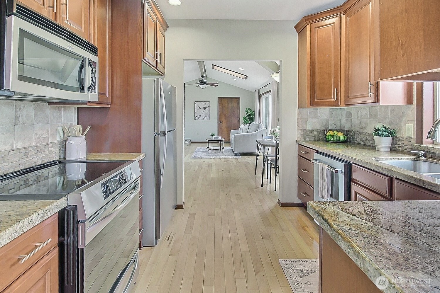 21834 Southeast 265th Way Maple Valley, WA 98038 - Photo 11 of 31 a kitchen with stainless steel appliances granite countertop a stove a sink and a microwave