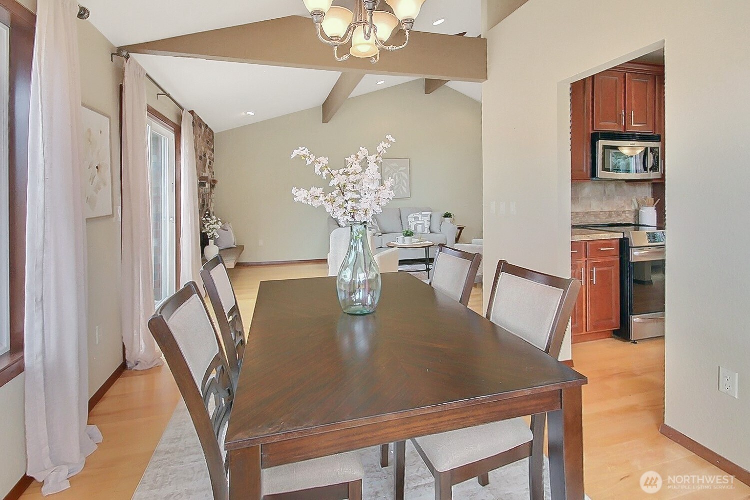 21834 Southeast 265th Way Maple Valley, WA 98038 - Photo 14 of 31 a view of a dining room with furniture and chandelier