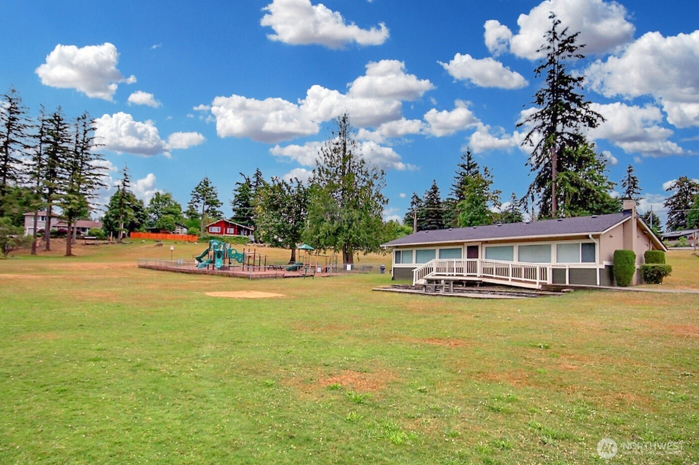 21834 Southeast 265th Way Maple Valley, WA 98038 - Photo 31 of 31 a view of a house with swimming pool and a yard