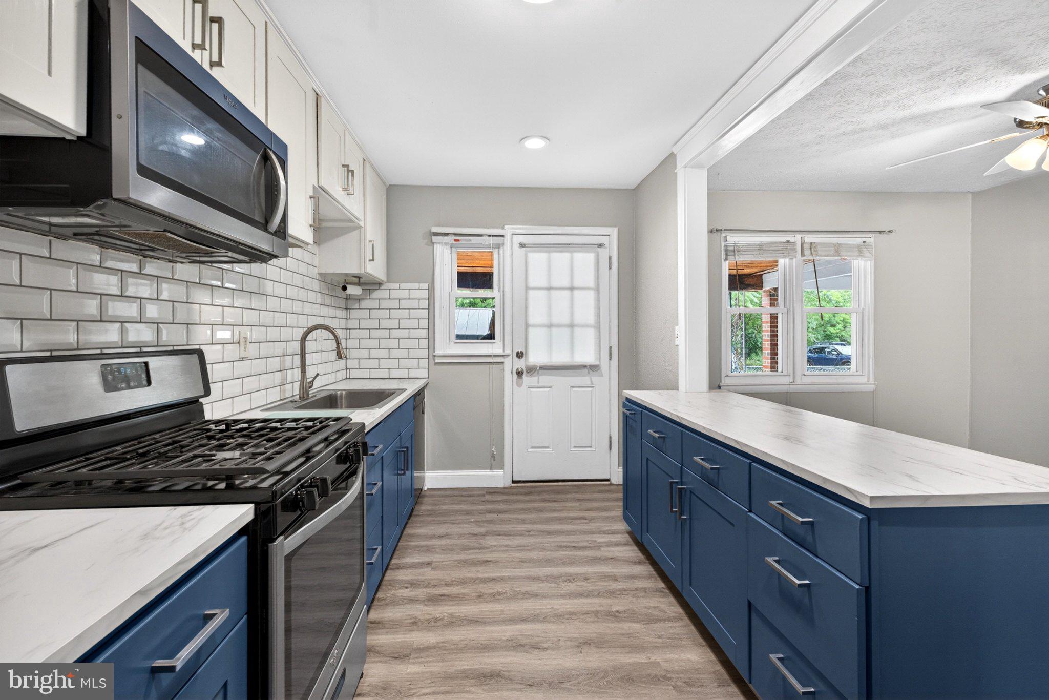7729 Charlesmont Road Baltimore, MD 21222 - Photo 14 of 38 Modern kitchen with stylish blue accents.