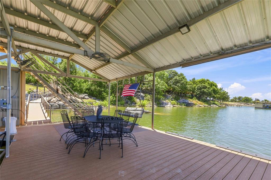 1005 Deep Water Road May, TX 76857 - Photo 36 of 40 Covered dock featuring composite decking, metal roof, and direct water access