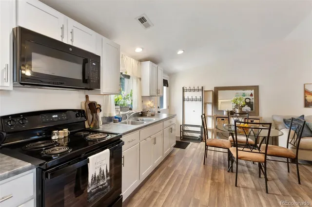 a kitchen with stainless steel appliances a stove microwave and cabinets