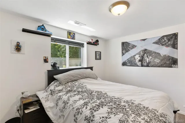 a bedroom with a bed and a large window