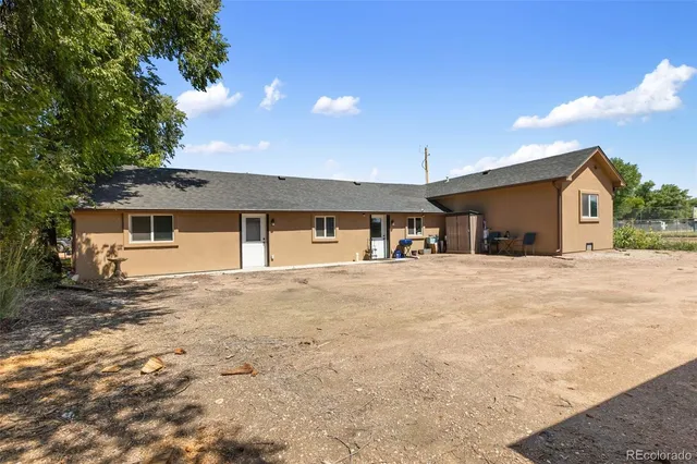 a view of a house with a backyard and a garage