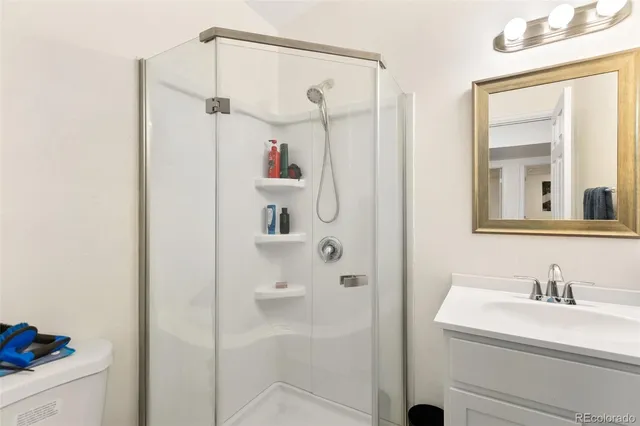 a bathroom with a shower sink and a mirror