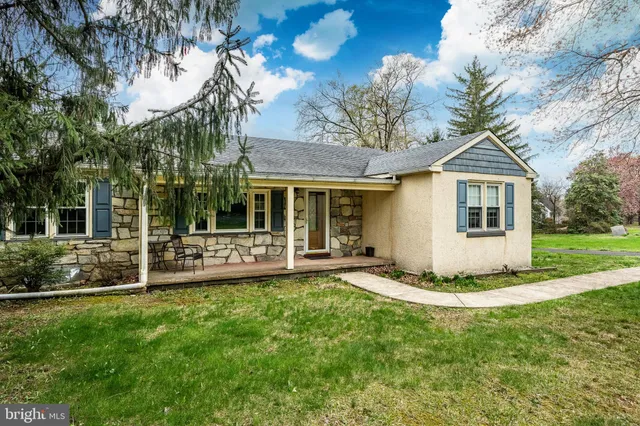 a view of a house with a yard and sitting area