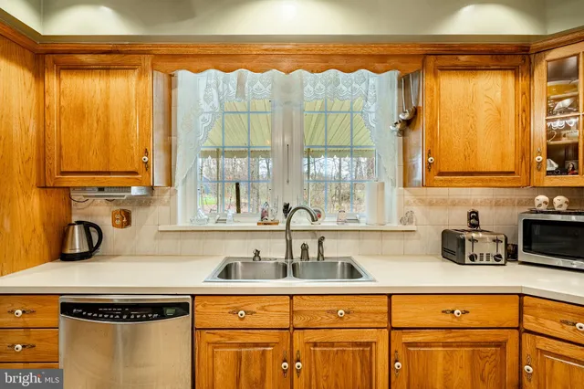 a kitchen with stainless steel appliances a sink a stove and a microwave