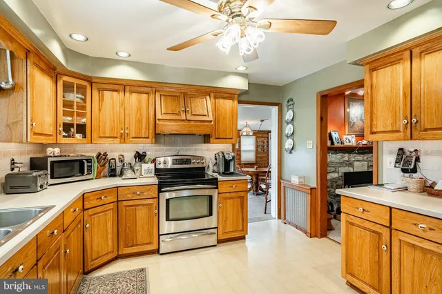 a kitchen with stainless steel appliances granite countertop a stove cabinets and refrigerator