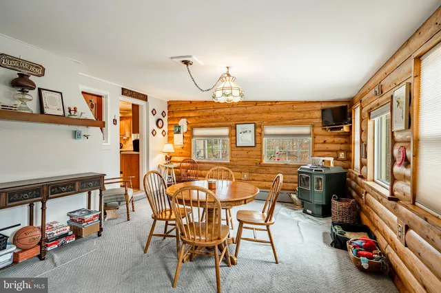 a dining room with furniture and a window