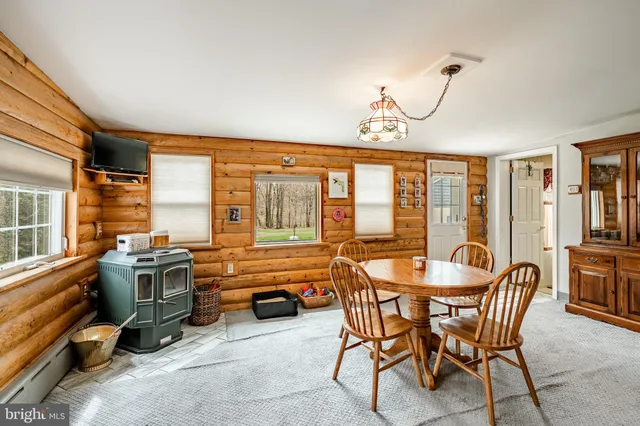 a view of a dining room with furniture large windows and wooden floor