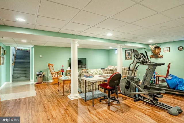 a living room with furniture rug and kitchen view