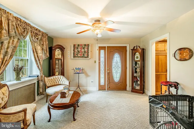 a living room with furniture a flat screen tv and a window
