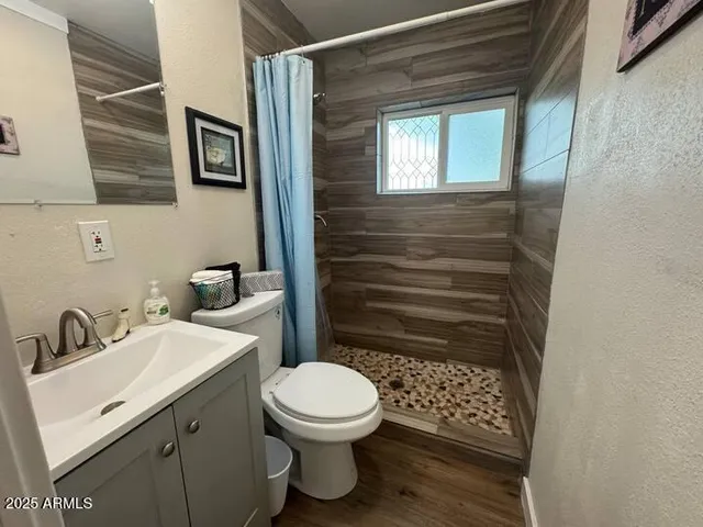 a bathroom with a toilet a sink and a window