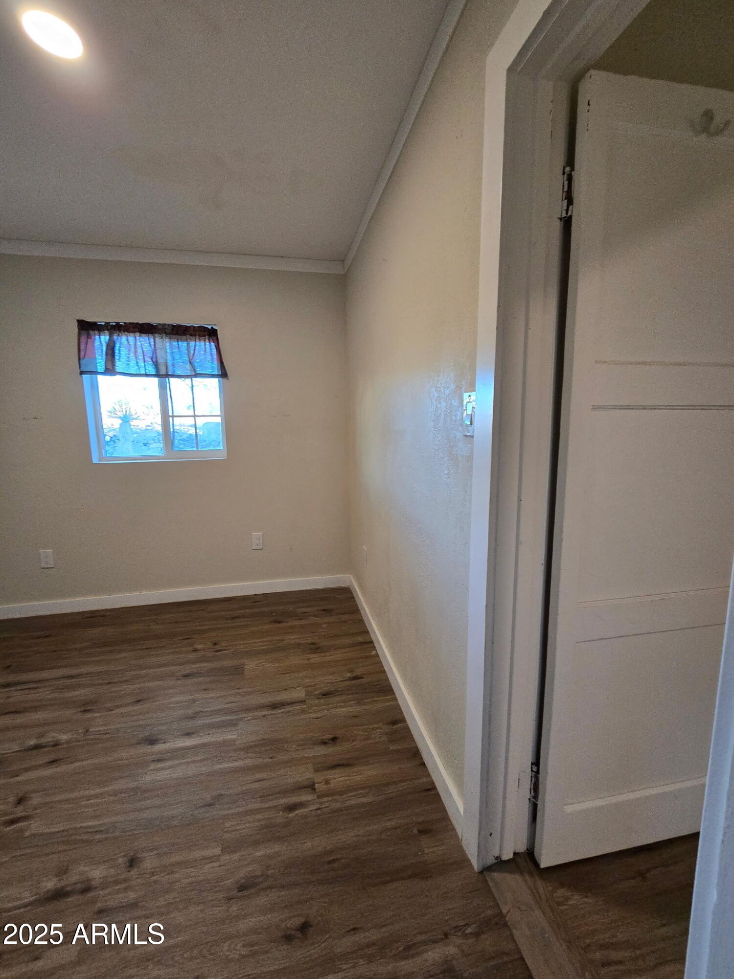 19 West Fremont Street, Unit 4 Tombstone, AZ 85638 - Photo 11 of 14 a view of an empty room with wooden floor and a window