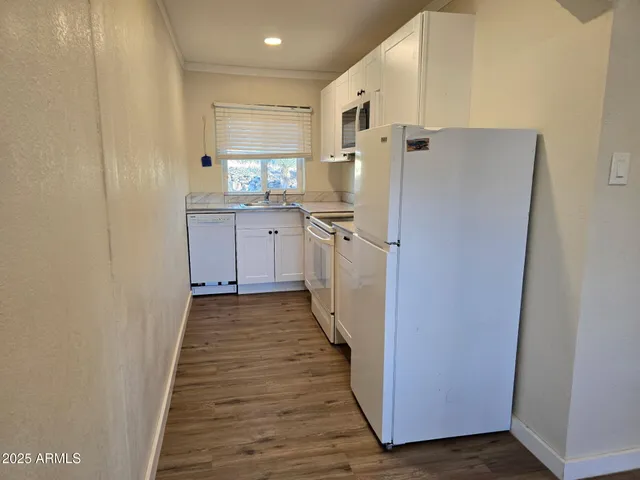 a kitchen with a refrigerator a sink and dishwasher